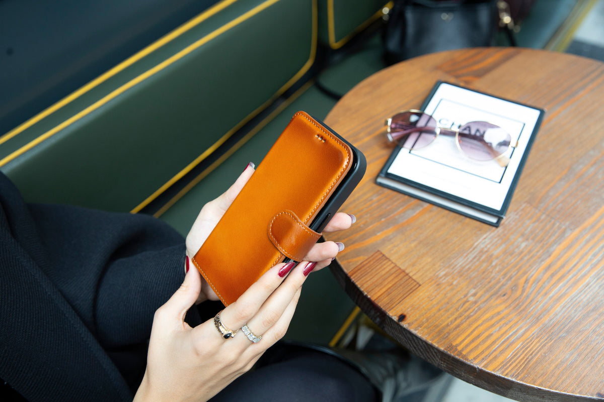 Tan genuine leather folio wallet case for Samsung Galaxy S26 series in a lifestyle setting