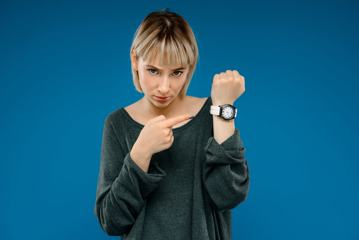 portrait-young-woman-with-watch-blue-wall