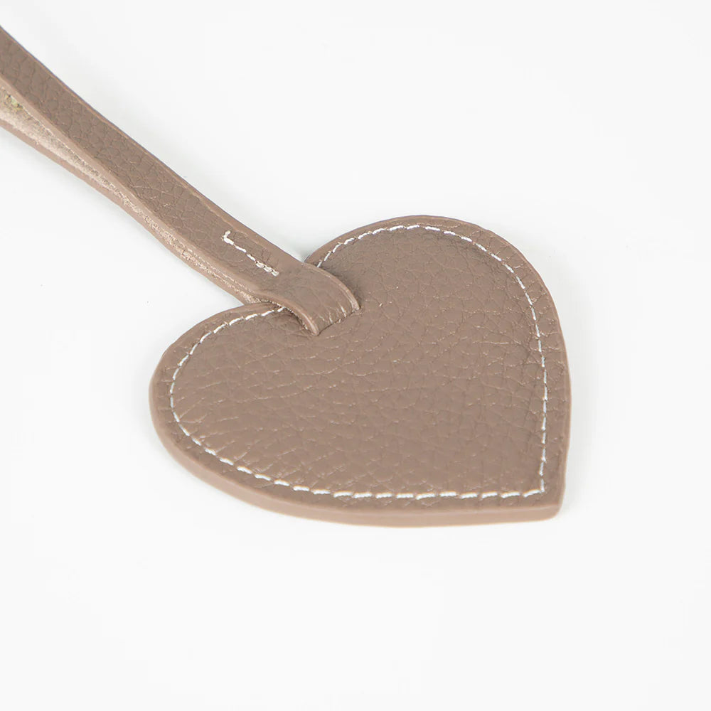 Heart-shaped leather charm with stitching detail on a white background
