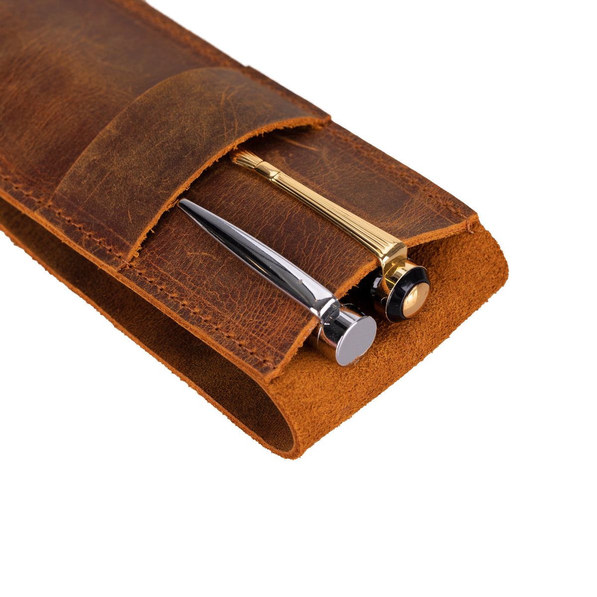 Brown leather pen holder with a pen and gold clip on a white background