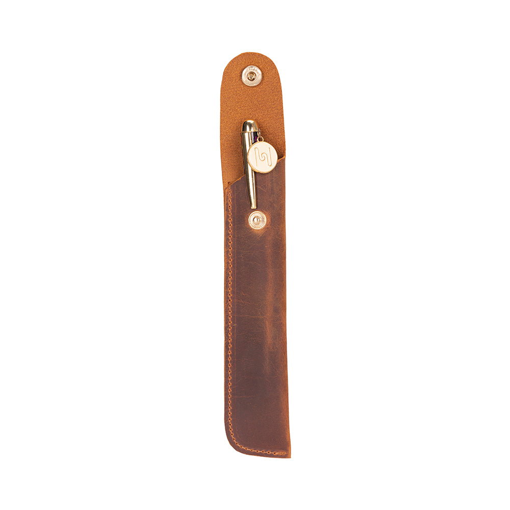 Brown leather pen holder with a pen inside on a white background