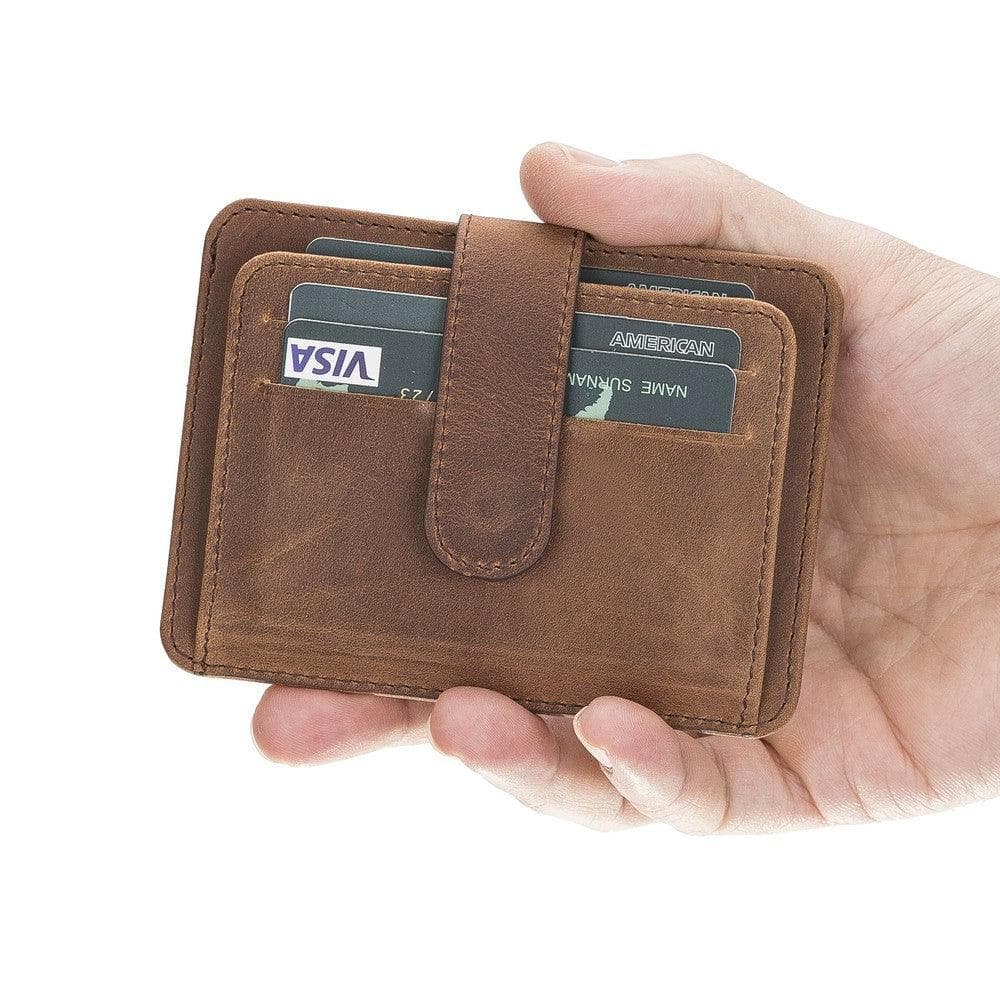 Brown leather wallet with card slots held in a hand against a white background