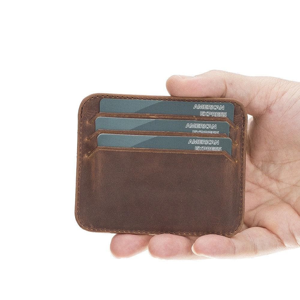 Hand holding a brown leather wallet with American Express cards on a white background