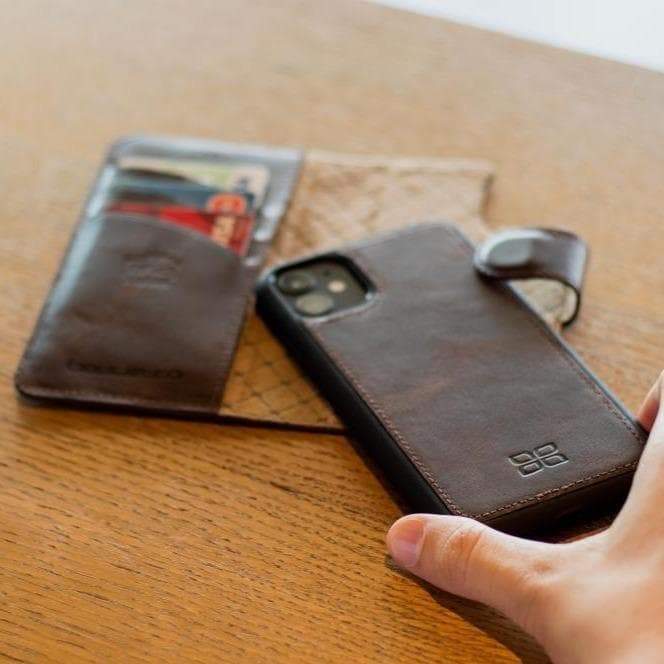 Brown leather phone case and wallet on a wooden surface