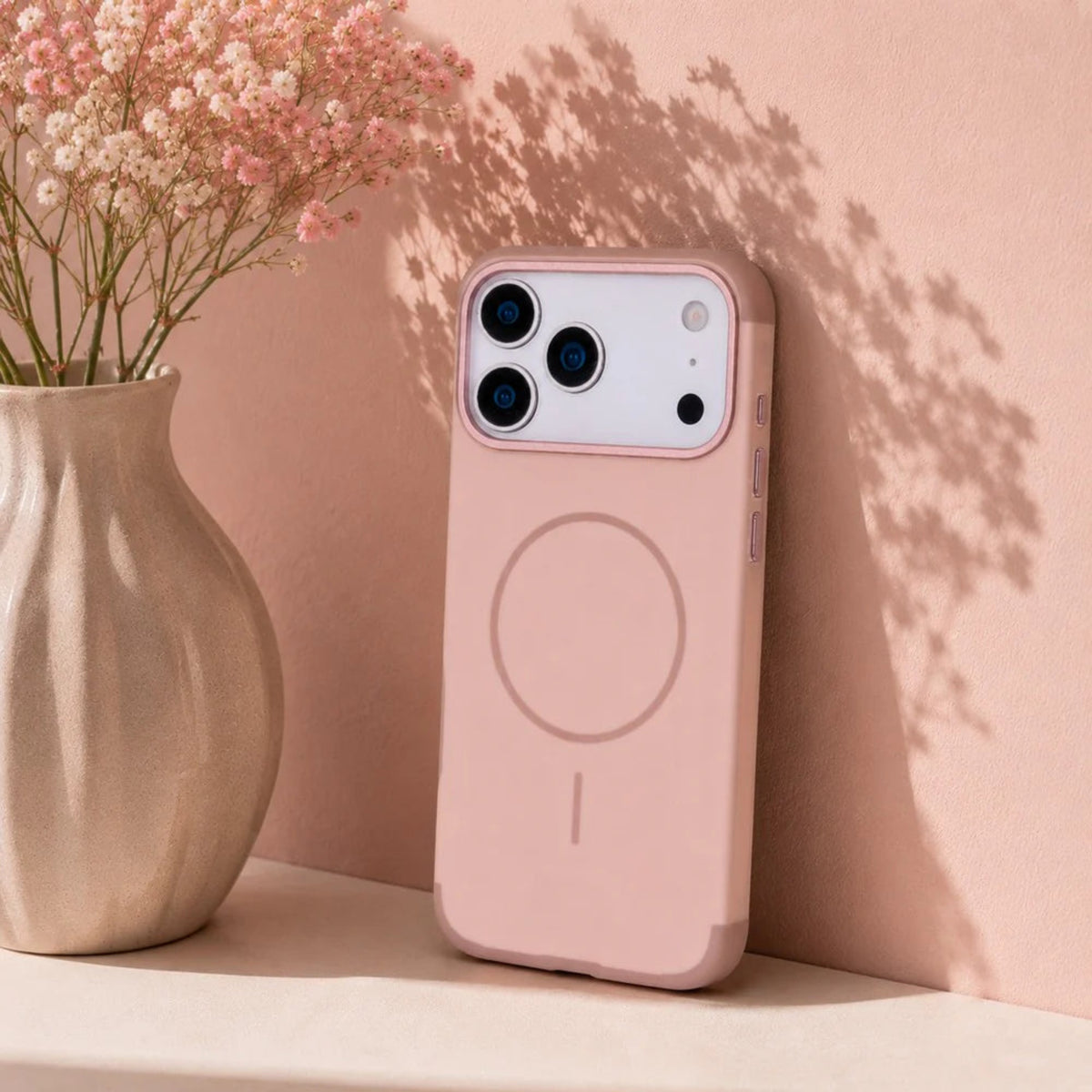 Pink phone case with a floral arrangement on a pink background