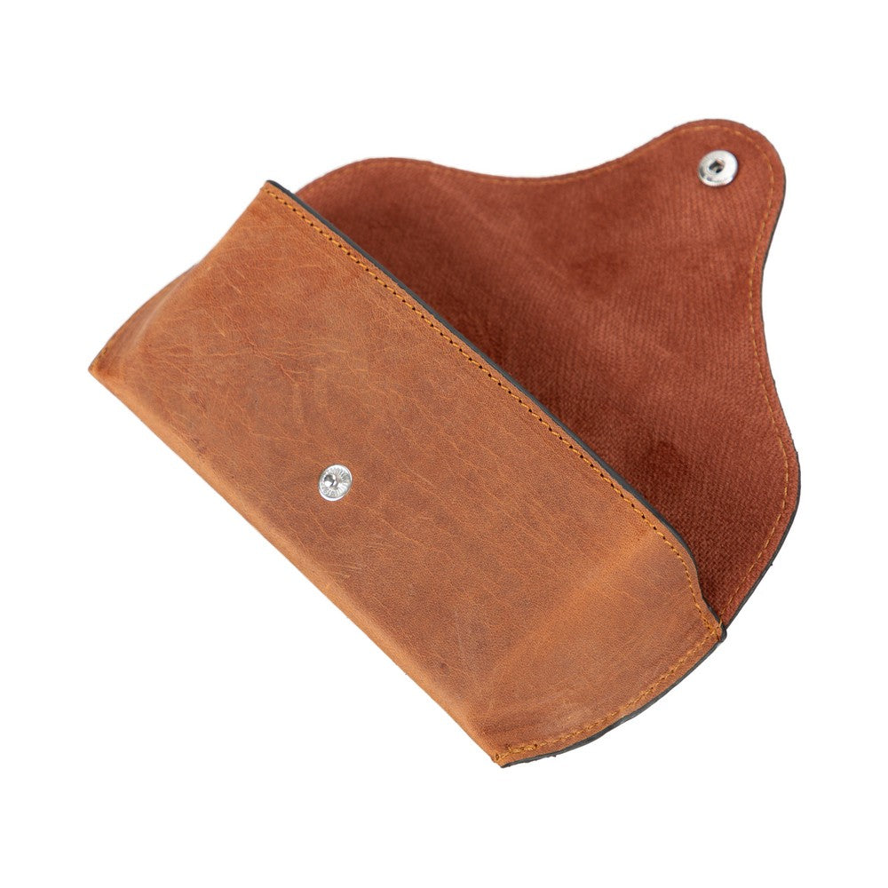 Brown leather pouch with metal studs on a white background