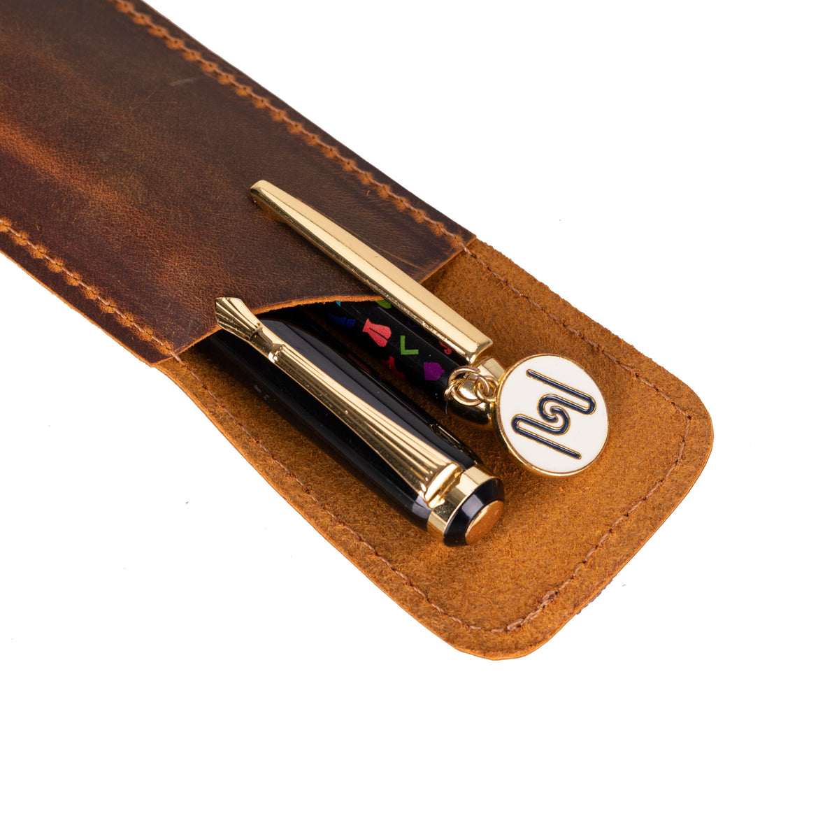 Pen with decorative charm in a brown leather case on a white background