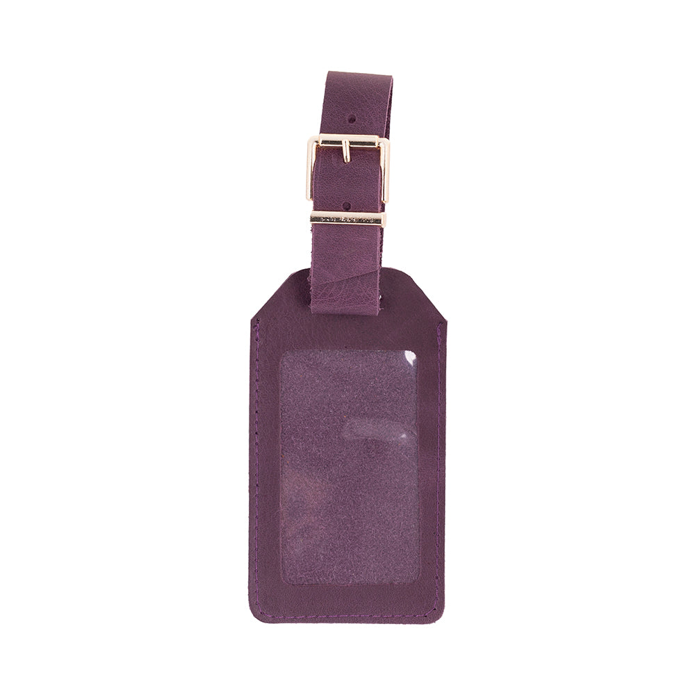 Purple leather luggage tag with a gold buckle on a white background
