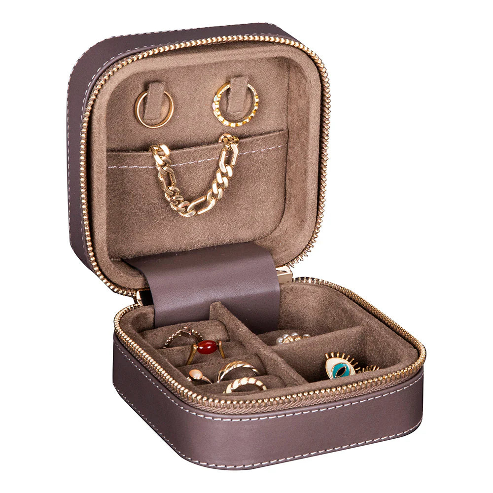 Brown jewelry case with gold and silver jewelry inside on a white background