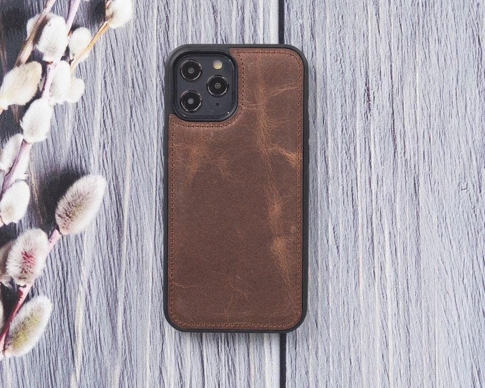 Brown leather phone case on a wooden surface with floral elements