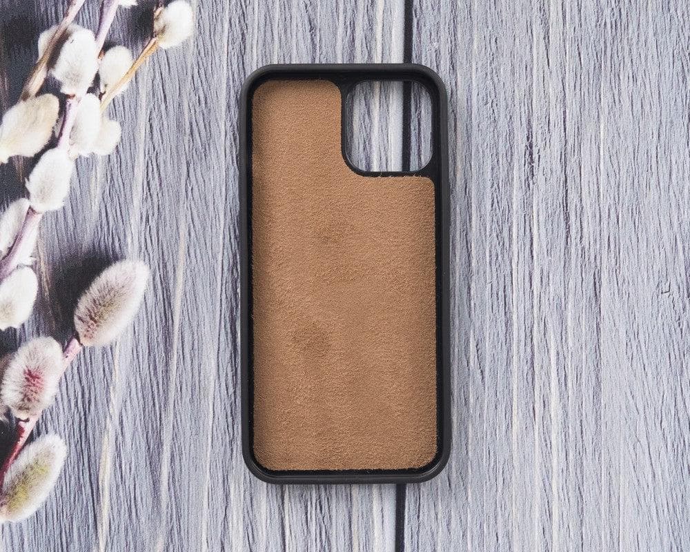 Phone case with brown back and black frame on a wooden surface with floral elements.