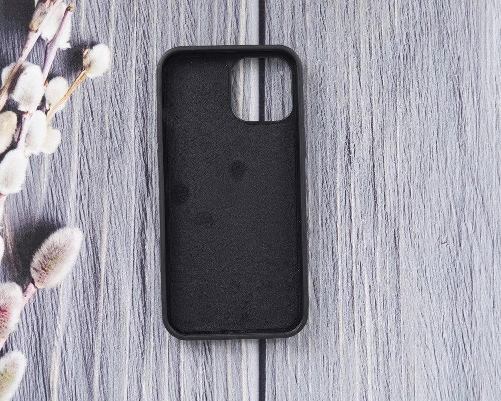 Black phone case on a gray wooden surface with floral decorations