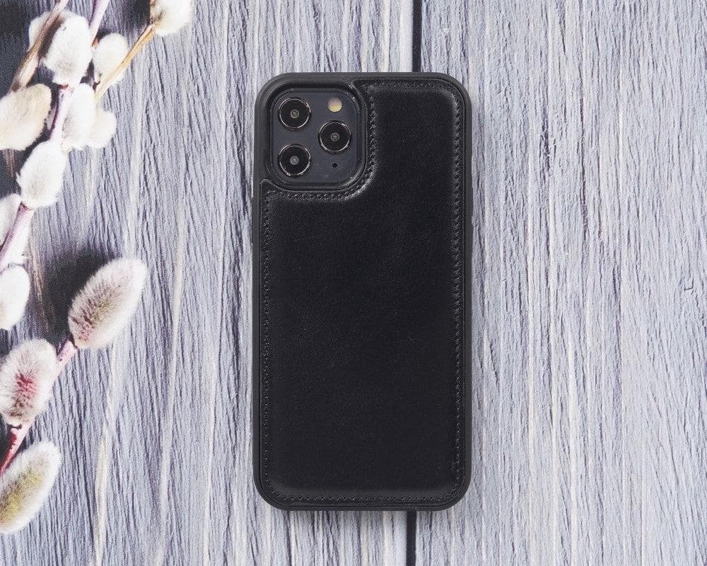 Black phone case on a wooden surface with floral decorations