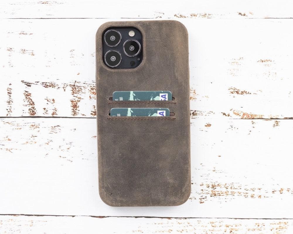 Brown leather phone case with card slots on a white wooden surface