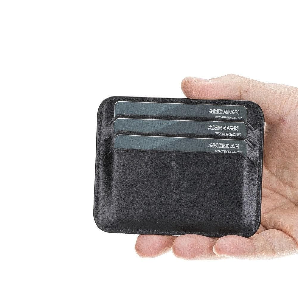 Hand holding a black cardholder with American Express cards on a white background