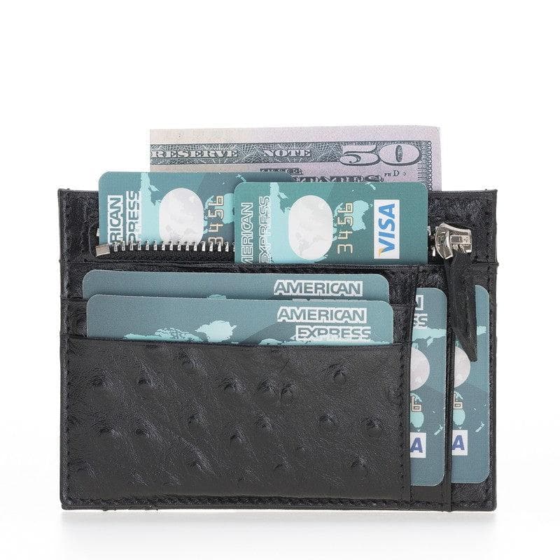 Black textured wallet with cards and money on a white background