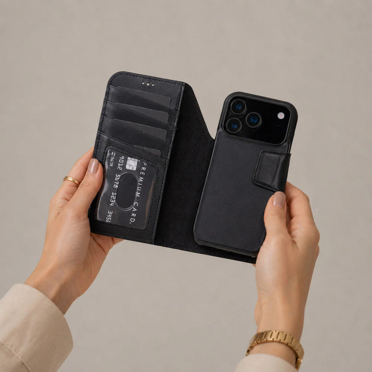 Black iphone 17 pro max case with card slots held by hands against a beige background