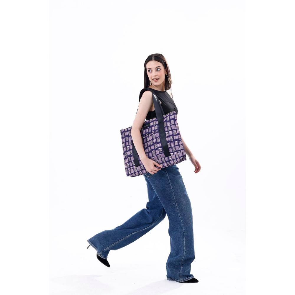 Woman holding a purple and black checkered bag on a white background